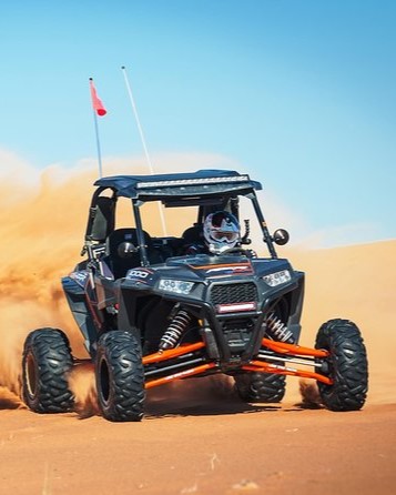 man-riding-buggy-in-desert
